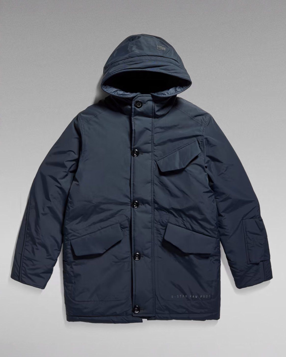 G-Star RAW navy hooded parka with large flap pockets, flat lay on grey gradient background