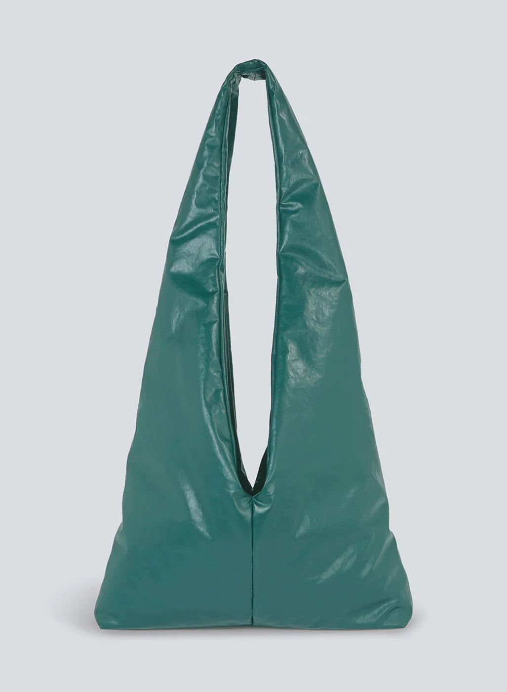 Teal green glossy slouchy hobo shoulder bag with long strap on pale grey background