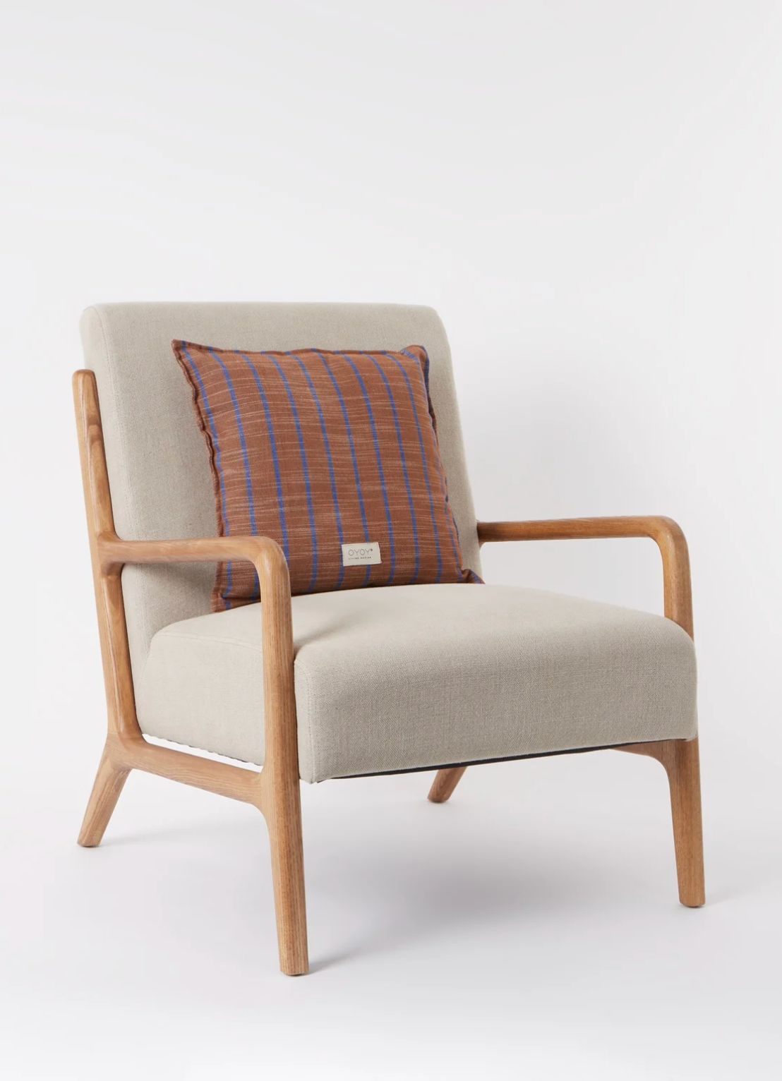 Wooden-frame armchair with beige upholstery and brown striped cushion on a light grey studio background