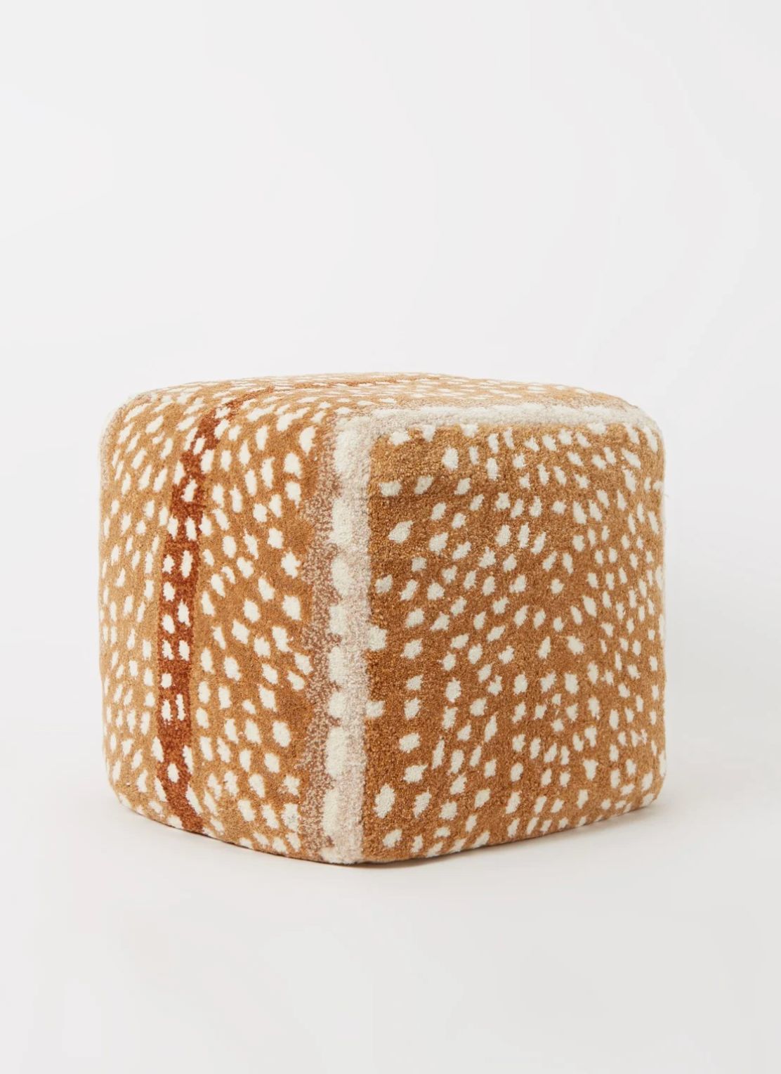 Square pouf covered in tan fabric with cream spots and brown stripe, on light grey studio background