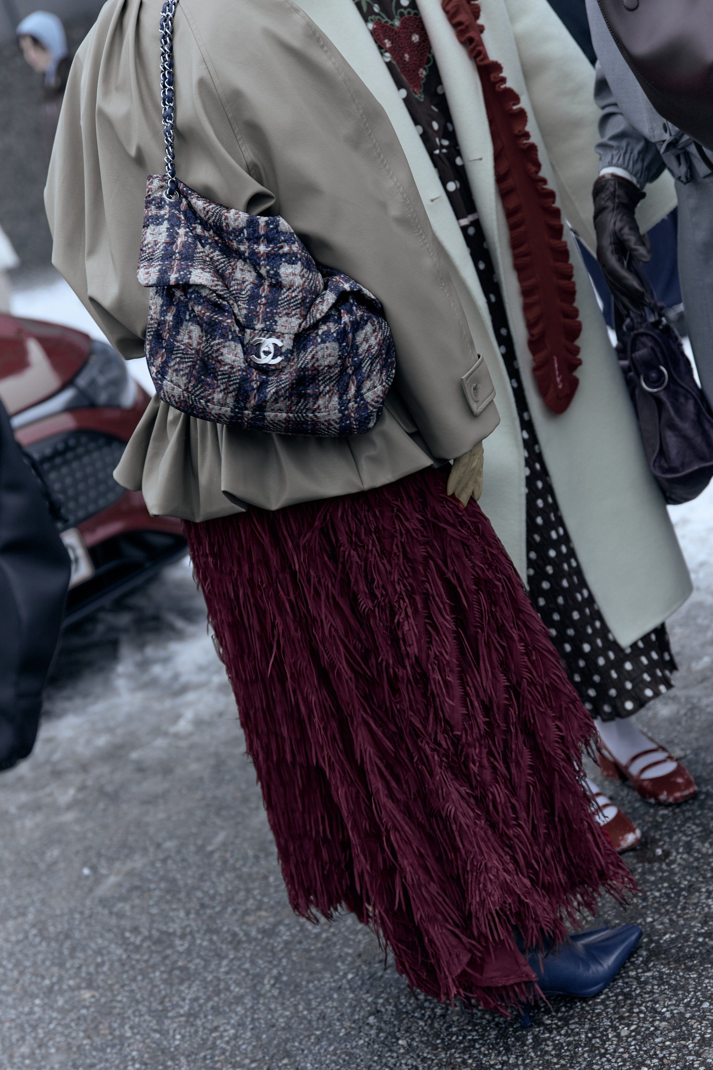 Copenhagen Fashion Week street style: tweed shoulder bag, sage jacket and burgundy feathered skirt in snow