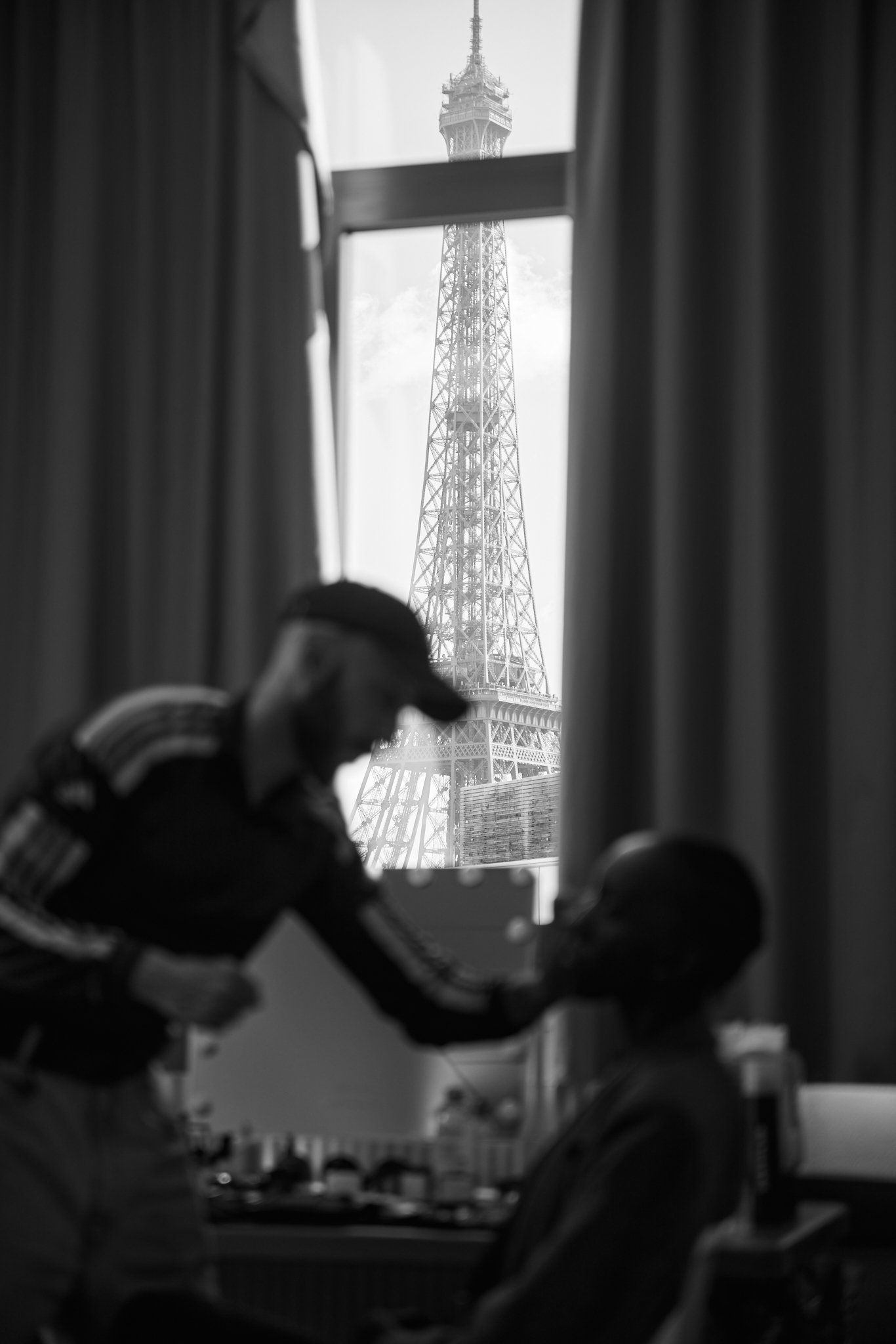 Black-and-white backstage at the MaXhosa Africa show: make-up in progress, the Eiffel Tower in the window